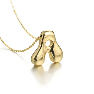 Close-up detail shot of a gold-plated puffy letter A pendant necklace with delicate chain.