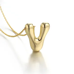 Gold puffy letter pendant necklace detail, 18k gold plated initial charm jewelry for women.