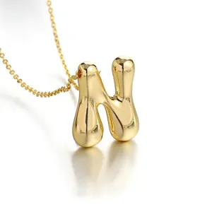 Gold plated puffy letter N pendant necklace, minimalist 18k gold initial chain detail.