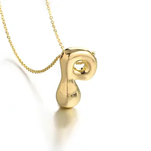 Detail shot of a trendy 18k gold plated puffy letter P pendant necklace with fine chain.