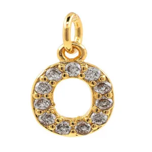 Close up detail of the gold letter O pendant showcasing sparkling micro pave cubic zirconia stones.