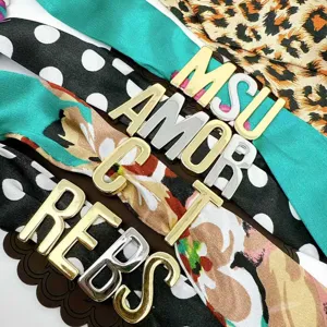 Brass gold plated large DIY alphabet letter charms with stylish patterned fabric straps.