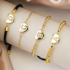 Pulsera de dije de letra inicial de corazon de cobre banado en oro, joyeria fina.