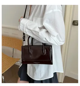 Vintage brown leather crossbody bag with top handle, chic casual shoulder bag for women.