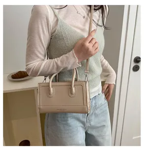 Close-up detail of stylish minimalist beige shoulder bag, premium PU leather everyday handbag