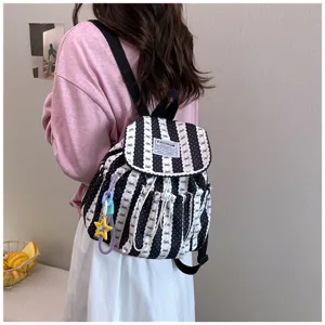 Detailed view of casual black and white striped backpack, perfect for daily commute and school.
