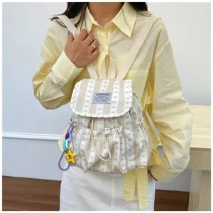 Casual striped mini backpack for women, stylish cute daypack with bow pattern for daily commute.