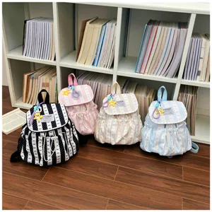 Detailed view of cute striped small backpacks in multiple colors with adorable keychain charms.