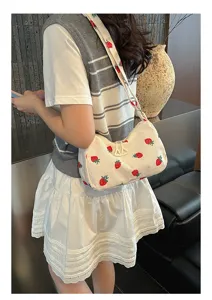 Detailed view of a cute strawberry print corduroy shoulder bag, stylish casual everyday use.