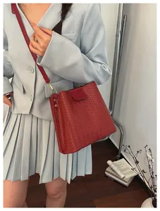 Trendy red woven leather shoulder bag, stylish bucket crossbody purse for women's daily commute.