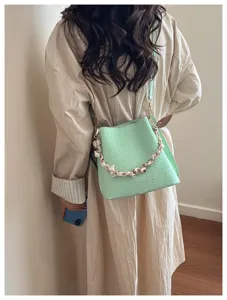 Green woven leather bucket bag with chain strap, retro shoulder bag for women daily use.