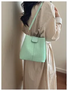 Woven bucket shoulder bag for women, stylish mint green crossbody bag with premium design.