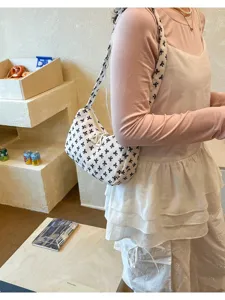 Chic pleated shoulder bag with bow print, casual versatile design, perfect everyday accessory.