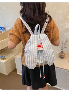 Cute striped bunny ear backpack detail view, showing fabric texture and adjustable shoulder straps.