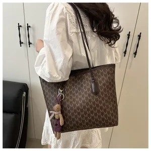 Large capacity brown monogram tote bag for women, stylish commuting shoulder bag with cute rabbit pendant.
