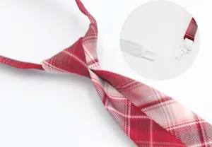 Close-up detail shot of the red plaid JK uniform tie showing elastic band and plastic clasp.