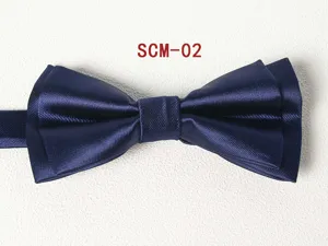 Detail shot of a dark blue double layered bow tie with elegant textured fabric finish.