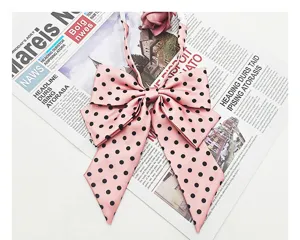 Pink polka dot bow tie with double layer oblique design, perfect JK uniform accessory for shirts.