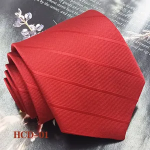 Close up view of the folded red men's jacquard tie showing detailed fabric texture and fine weaving.
