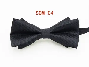 Detailed close-up of a classic black textured men's formal bow tie, showing fabric.