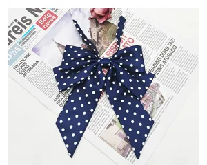 Detailed close-up of the navy blue white polka dot JK bow tie, elegant college style accessory.