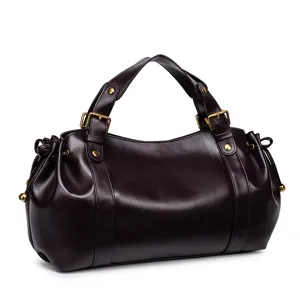 Detailed view of the dark brown soft leather retro handbag with metal buckles and side pleats.