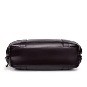 Detailed bottom view of the dark brown leather handbag, highlighting durable structure.