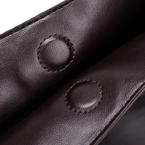 Close-up of dark brown soft leather women handbag magnetic snap closure detail stylish design