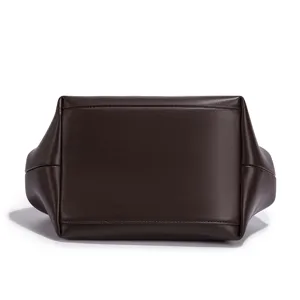Dark brown leather women handbag bottom detail, minimalist casual shoulder bag design.