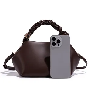 Brown women handbag detail view, showing unique braided handle and shell shape design.