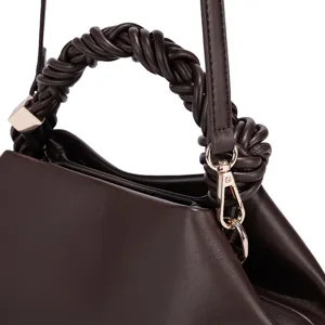 Close-up view of a stylish dark brown women's leather handbag featuring an elegant braided handle.