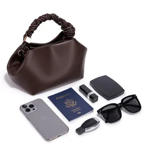 Stylish brown leather handbag with braided handle and spacious interior capacity display.