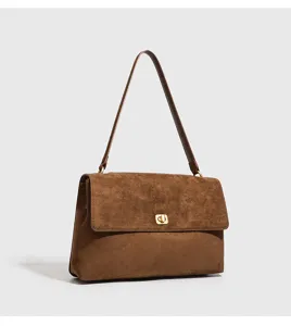 Brown suede shoulder bag detail, vintage commuter handbag with gold tone hardware lock.