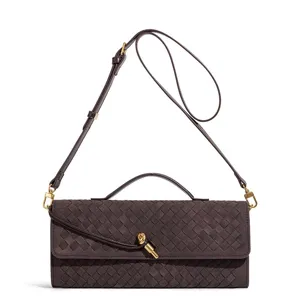 Dark brown woven leather shoulder bag with top handle, metal knot closure, and long strap.