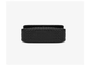 Vista detallada del bolso de hombro de cuero tejido negro, diseño de moda chic.