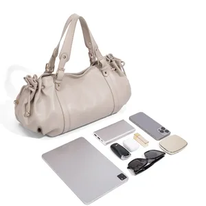 Detail view of minimalist solid beige leather Boston handbag with daily essentials capacity display.