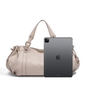 Minimalist beige leather shoulder bag for women, featuring elegant metal buckle and side drawstrings.
