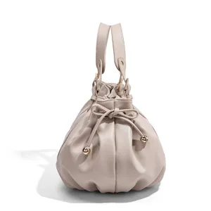 Detailed view of the stylish ruched handbag with convenient drawstring and top handles.