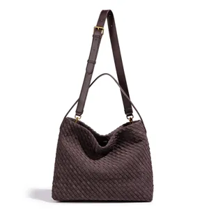 Detailed view of retro brown woven shoulder bag, showing fine handmade texture and durable straps.