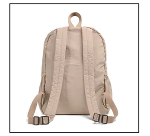 Detail view of the back straps and nylon texture of the minimalist casual beige backpack.