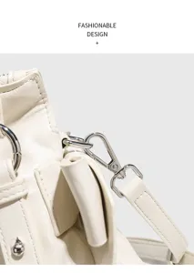 Detail view of stylish leather handbag hardware, metal buckles, and adjustable shoulder strap.