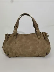 Casual solid color faux suede Boston handbag with metal buckle and double handles detail.