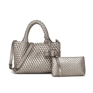 Stylish silver woven leather handbag set with adjustable strap and matching clutch bag.