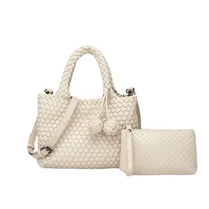 Chic woven leather handbag set with top handles, shoulder strap, and matching pouch for women.