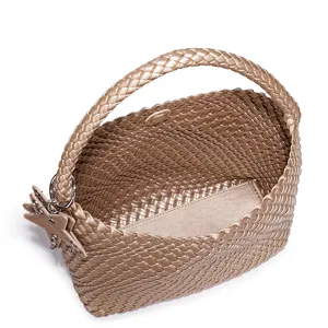 Detailed view of the trendy metallic gold woven handbag, large capacity stylish shoulder bag.