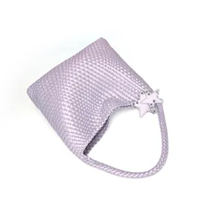 Detail view of the elegant lavender woven shoulder bag featuring charming star decorations.