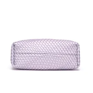 Detailed close-up of light purple woven leather handbag base showcasing fine texture.
