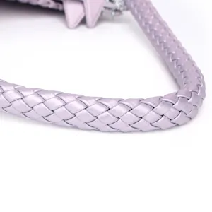 Detailed close-up of light purple woven leather handbag strap, premium texture and durable design.