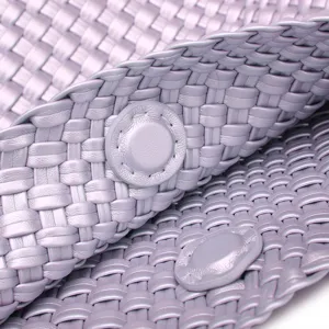 Detailed close-up of woven leather bag texture, showing exquisite craftsmanship and snap.