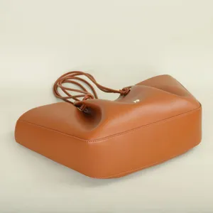 Elegant brown leather tote bag featuring knotted straps and spacious interior for daily commute.